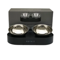 A set of elevated pet bowls for food and water, placed on a metal stand with non-slip feet.