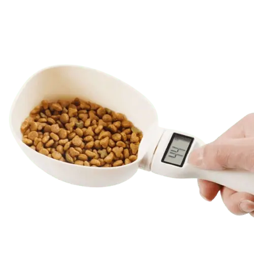 Electronic measuring spoon for pet food, shown with dog kibble