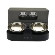 A set of elevated pet bowls for food and water, placed on a metal stand with non-slip feet.