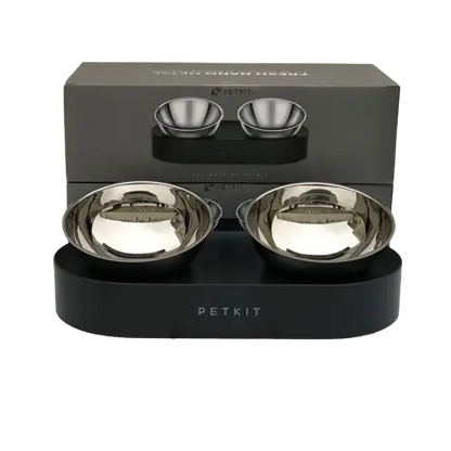 A set of elevated pet bowls for food and water, placed on a metal stand with non-slip feet.