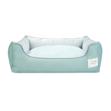 Green cotton dog bed with orthopedic support and removable cover, cozy and breathable for small and medium pets.