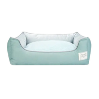 Green cotton dog bed with orthopedic support and removable cover, cozy and breathable for small and medium pets.